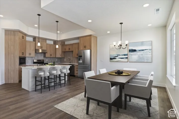 Open-concept kitchen and dining area featuring wood-finish flooring