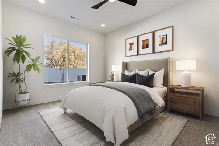Bedroom featuring a large multi-pane window, recessed lighting, and a ceiling fan