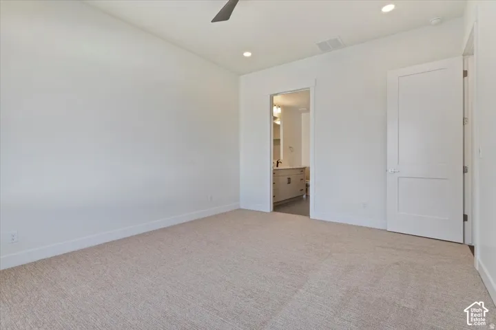 Carpeted room with recessed lighting and a ceiling fan