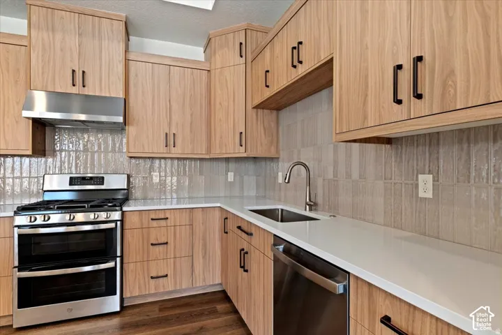 Kitchen with wood-finish cabinetry and matte black hardware