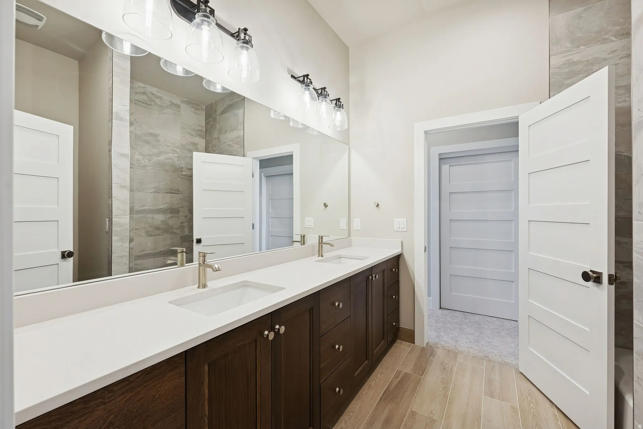 Dual vanity with integrated rectangular sinks, brushed nickel faucets, and white countertops