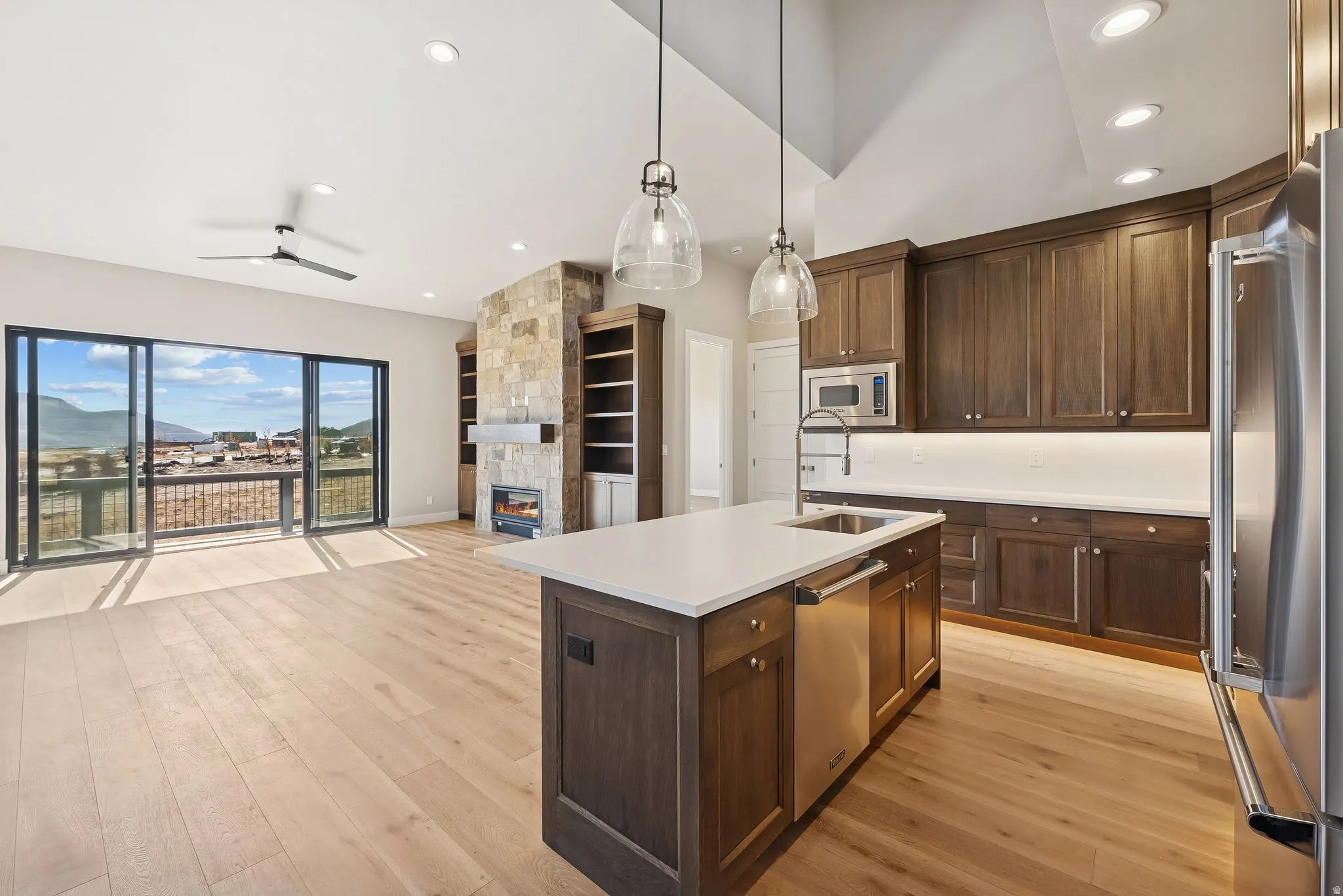 Open-concept living space with light wood-finish flooring