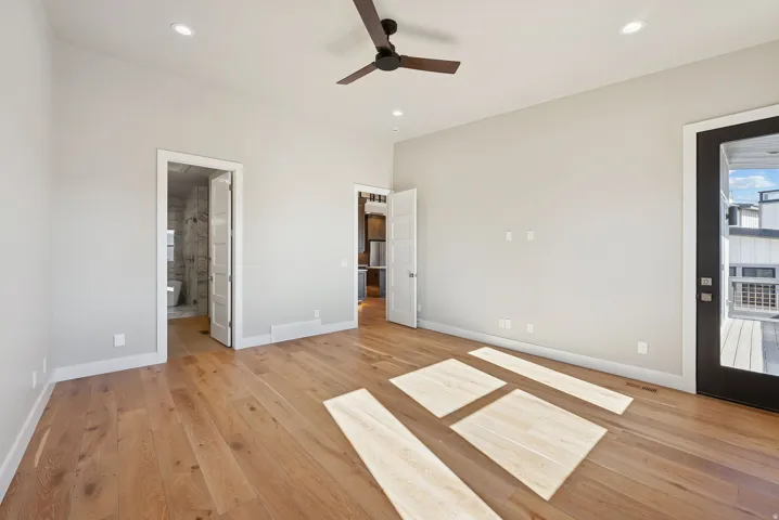 Spacious room featuring wood-finish flooring, recessed lighting, and a contemporary ceiling fan