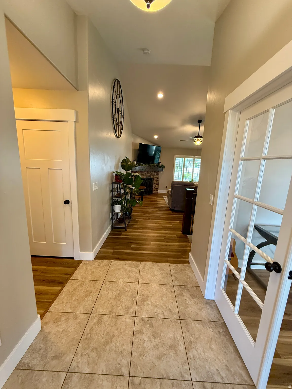 Entryway featuring neutral-toned tile flooring and a vaulted ceiling