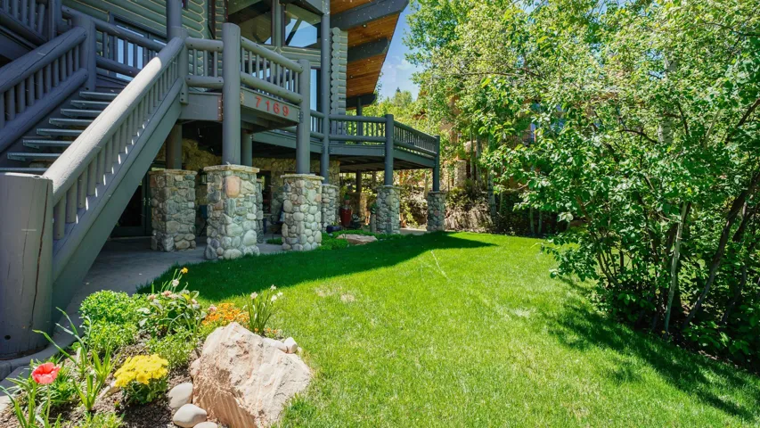 Stone-clad pillars supporting an exterior staircase and an upper-level balcony