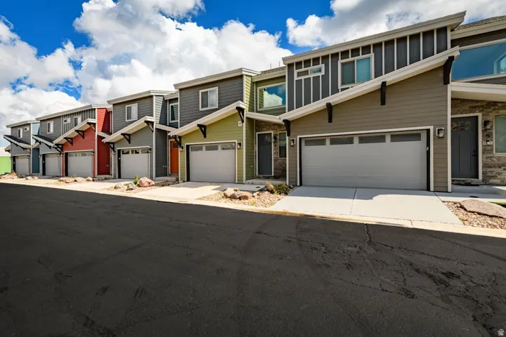 Modern multi-level townhomes featuring distinct architectural styles and individual garages