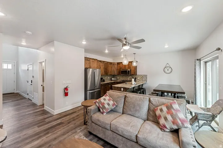 Open-concept living area featuring wood-finish flooring, recessed lighting, and a ceiling fan