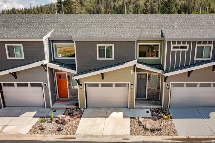 Modern townhome exteriors featuring varied siding materials including shake, vertical, and horizontal panels