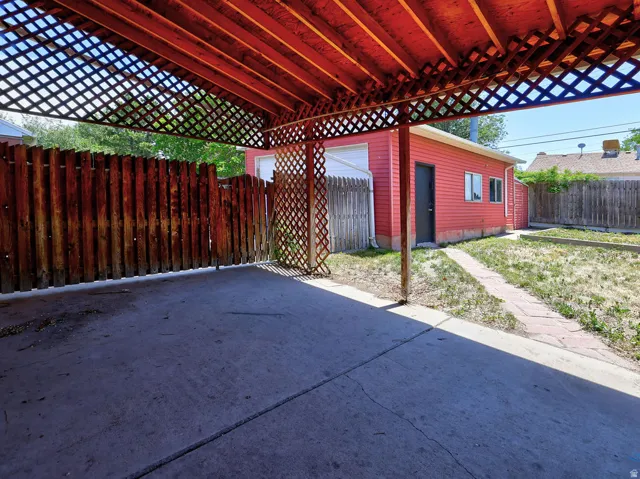 Carport with concrete slab and lattice wood ceiling