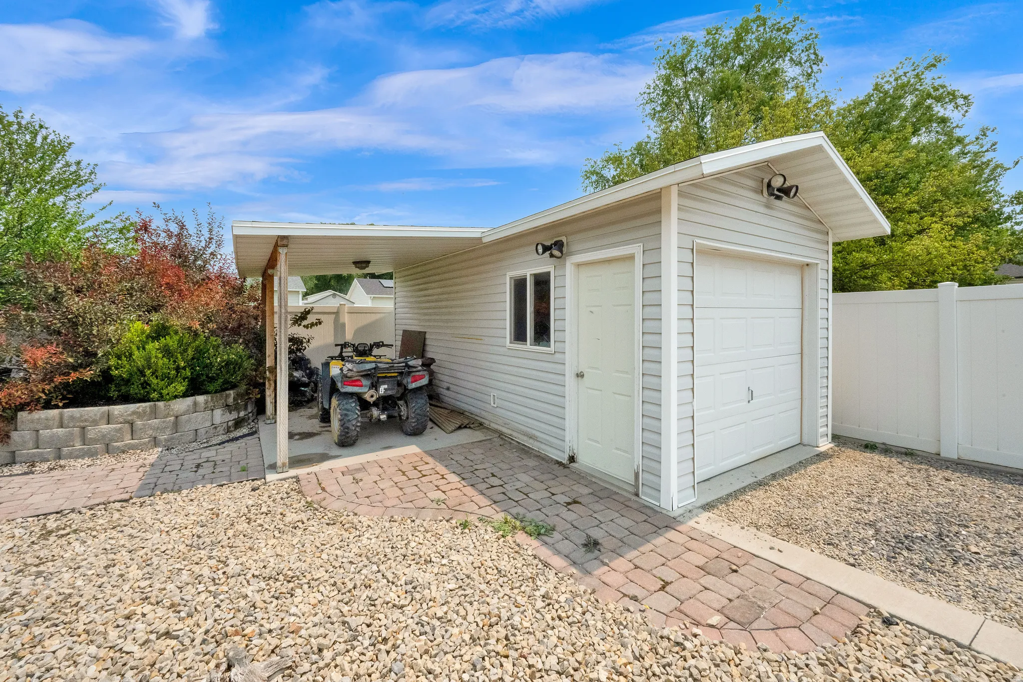 Detached garage with workshop, 88' X 8" door, 10' X 22' garage.  Featuring carport, with power and a side entry door.