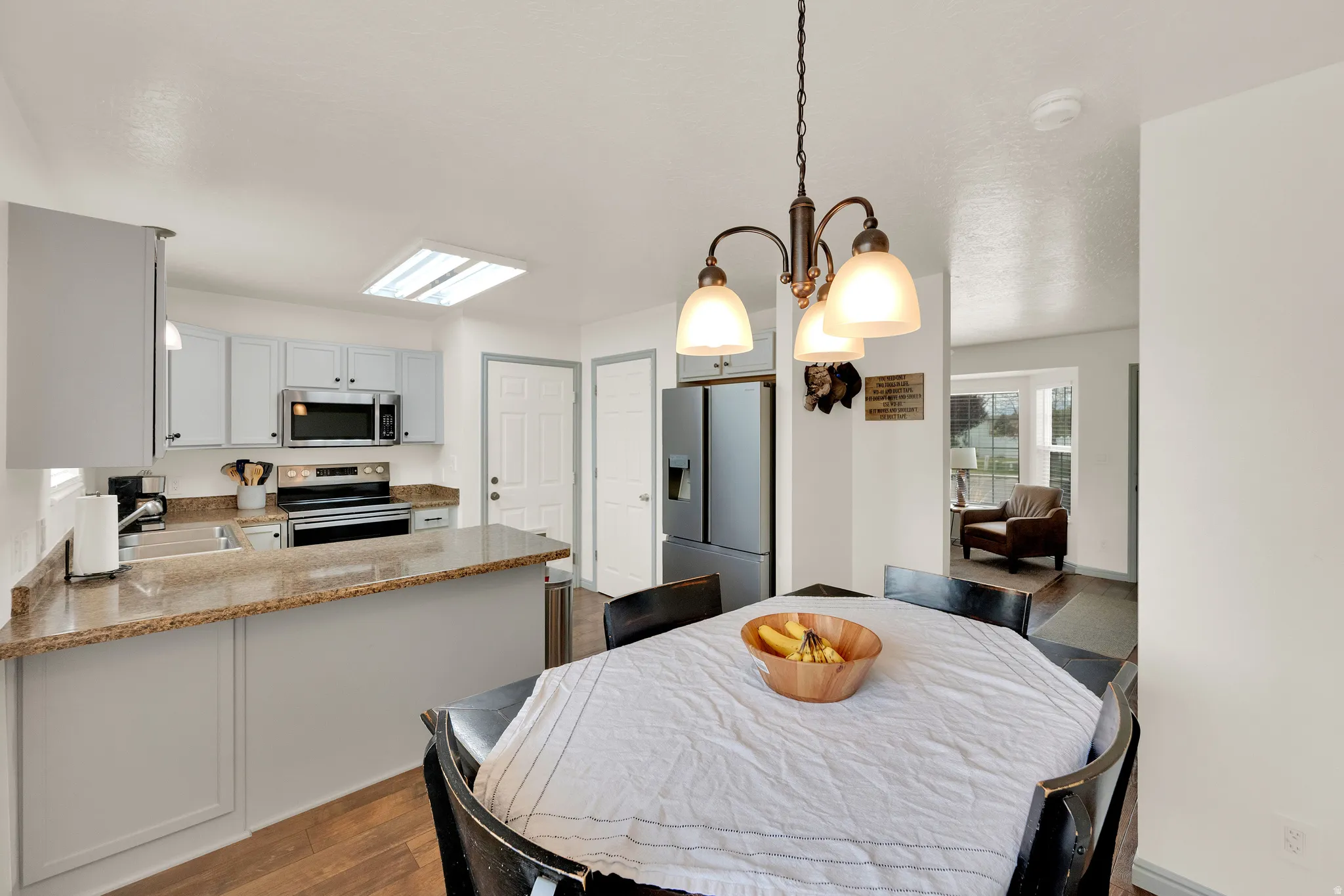 Dining area, kitchen and view of the front room.