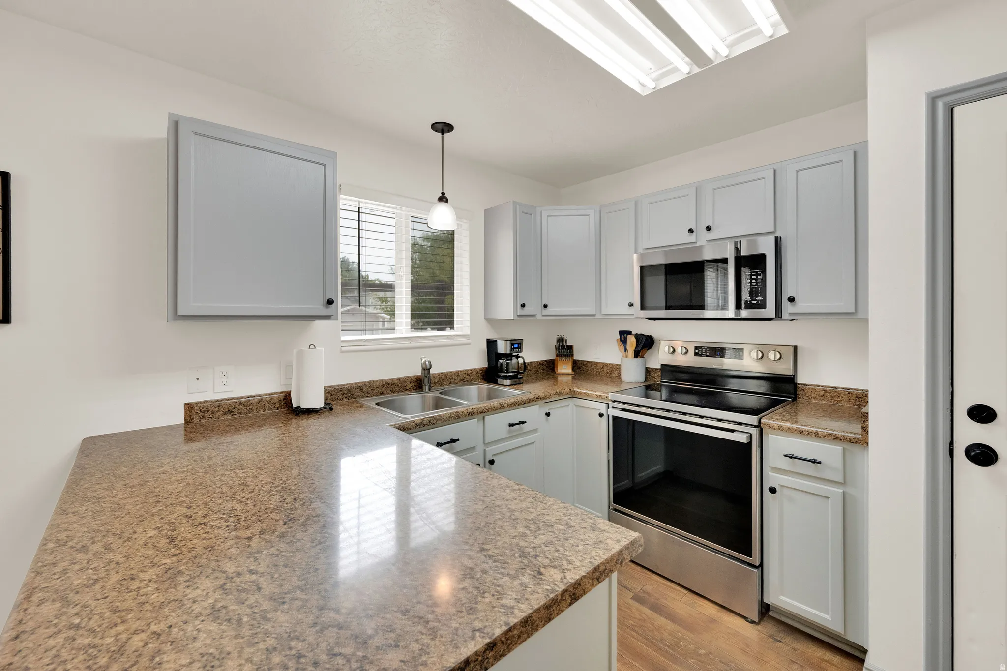 Kitchen featuring stainless steel appliances and glass cook-top.