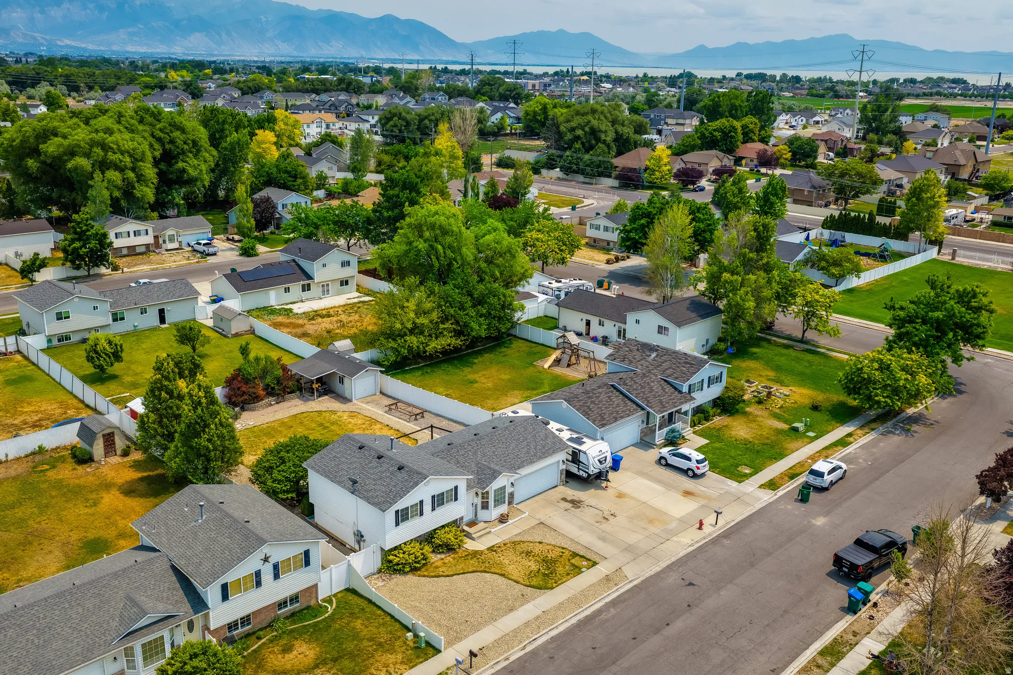 Aerial perspective showcasing a residential neighborhood with a distant mountain backdrop
