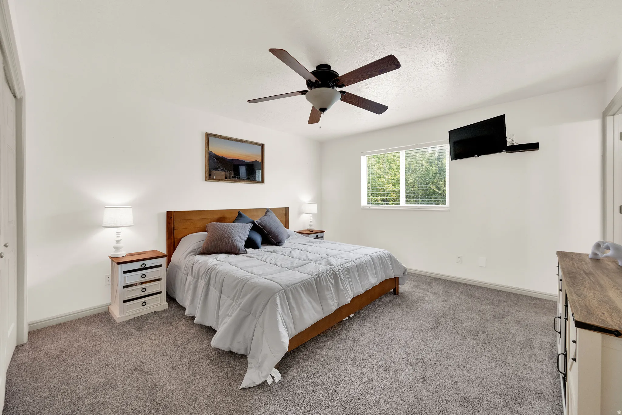 Primary bedroom featuring daylight window window and ceiling fan.