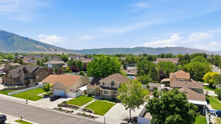 Aerial perspective showcasing a residential neighborhood with mountain backdrops