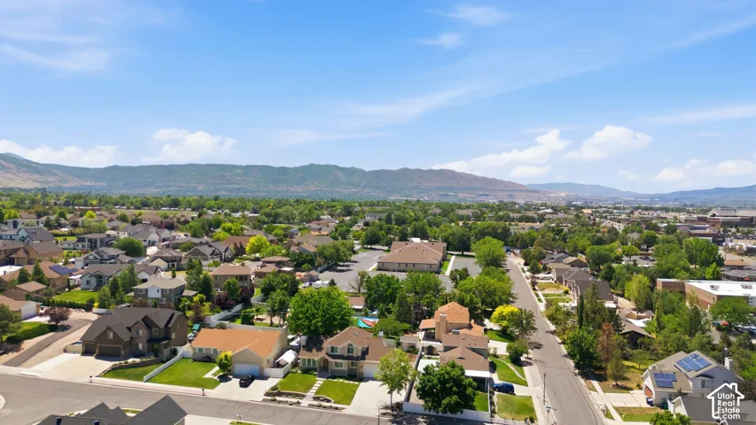 Expansive aerial perspective showcasing a residential neighborhood with distant mountain ranges