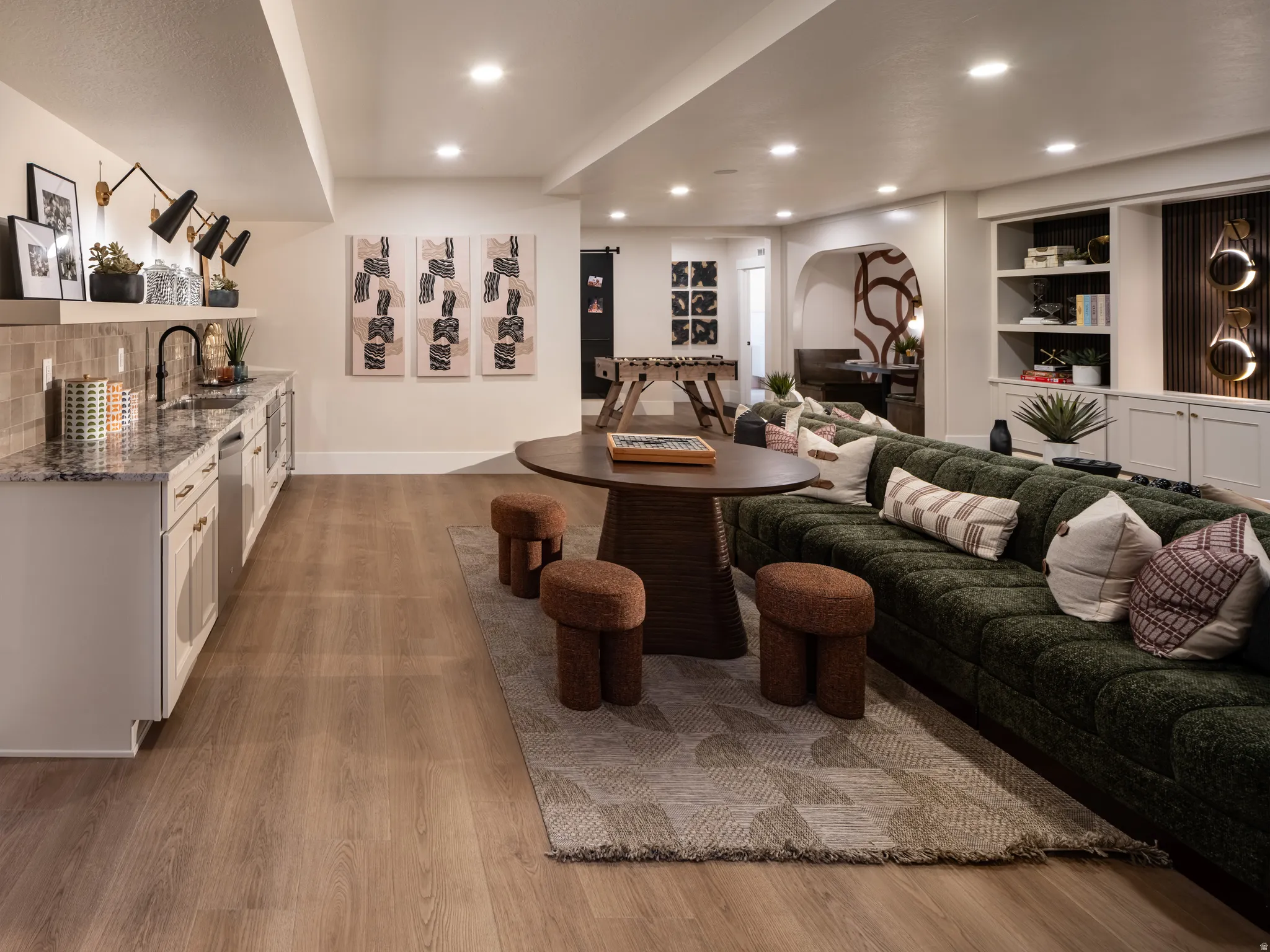 Entertainment space featuring wood-finish flooring and recessed lighting