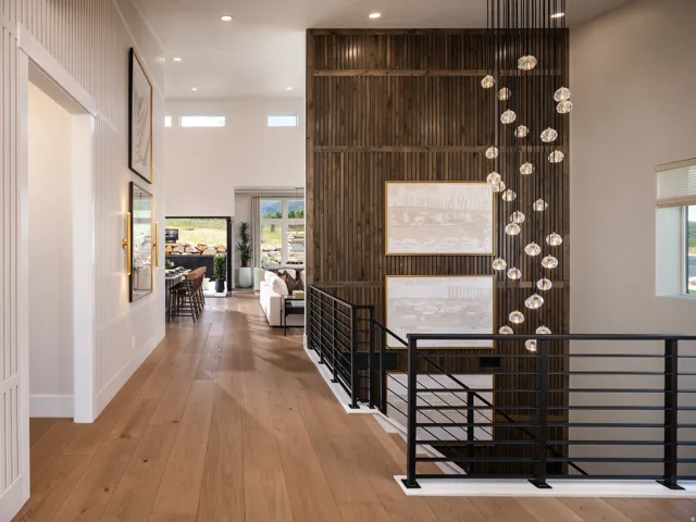 Wide plank wood-finish flooring throughout, complemented by a modern black metal railing system