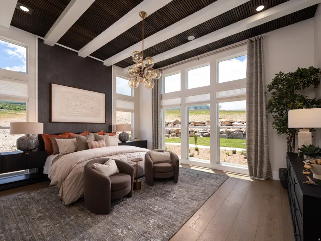 Spacious room featuring expansive windows, wood-finish flooring, a textured accent wall, and a beamed ceiling with recessed lighting