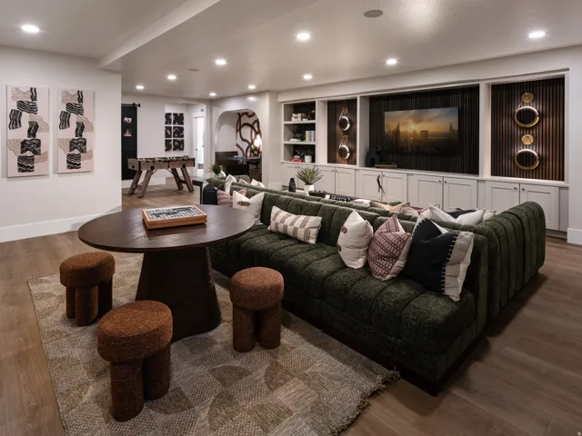 Expansive recreation room featuring wood-finish flooring, recessed lighting, and a built-in media center with cabinetry