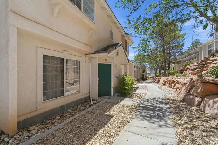 Stucco exterior with a contrasting dark green entry door