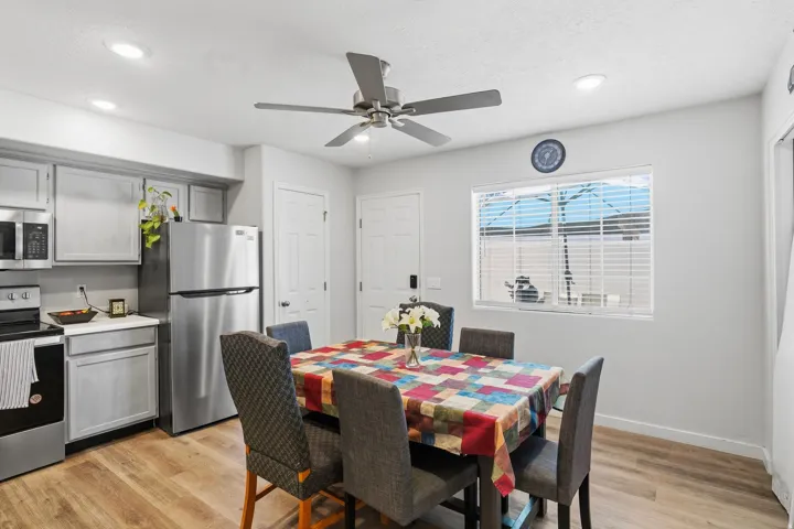 Dining area featuring wood-finish flooring, a ceiling fan with integrated lighting, and recessed ceiling lights