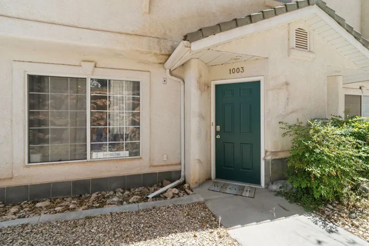 Entryway featuring a dark green paneled door with prominent house numbering
