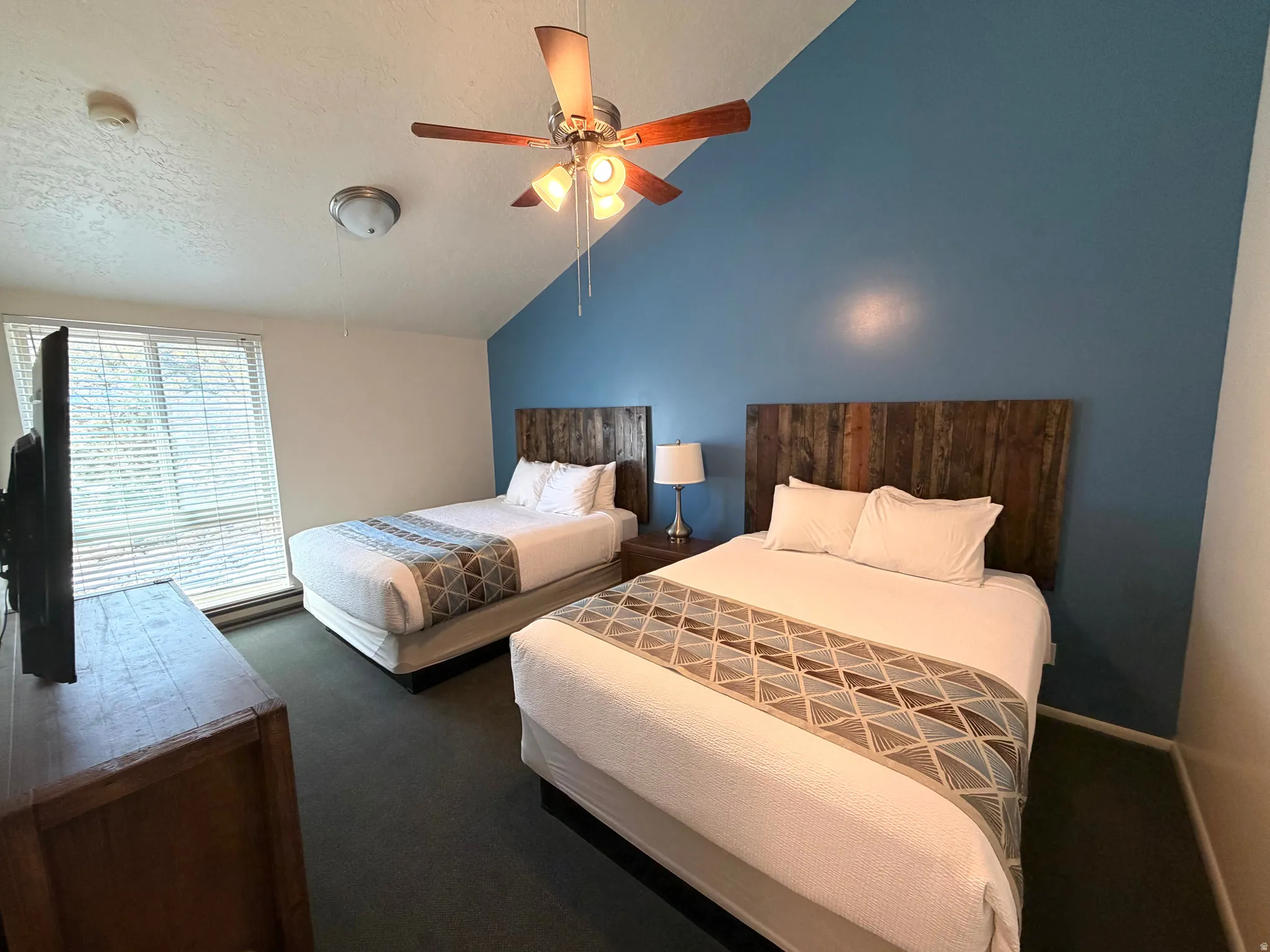 Vaulted ceiling with a ceiling fan and recessed lighting