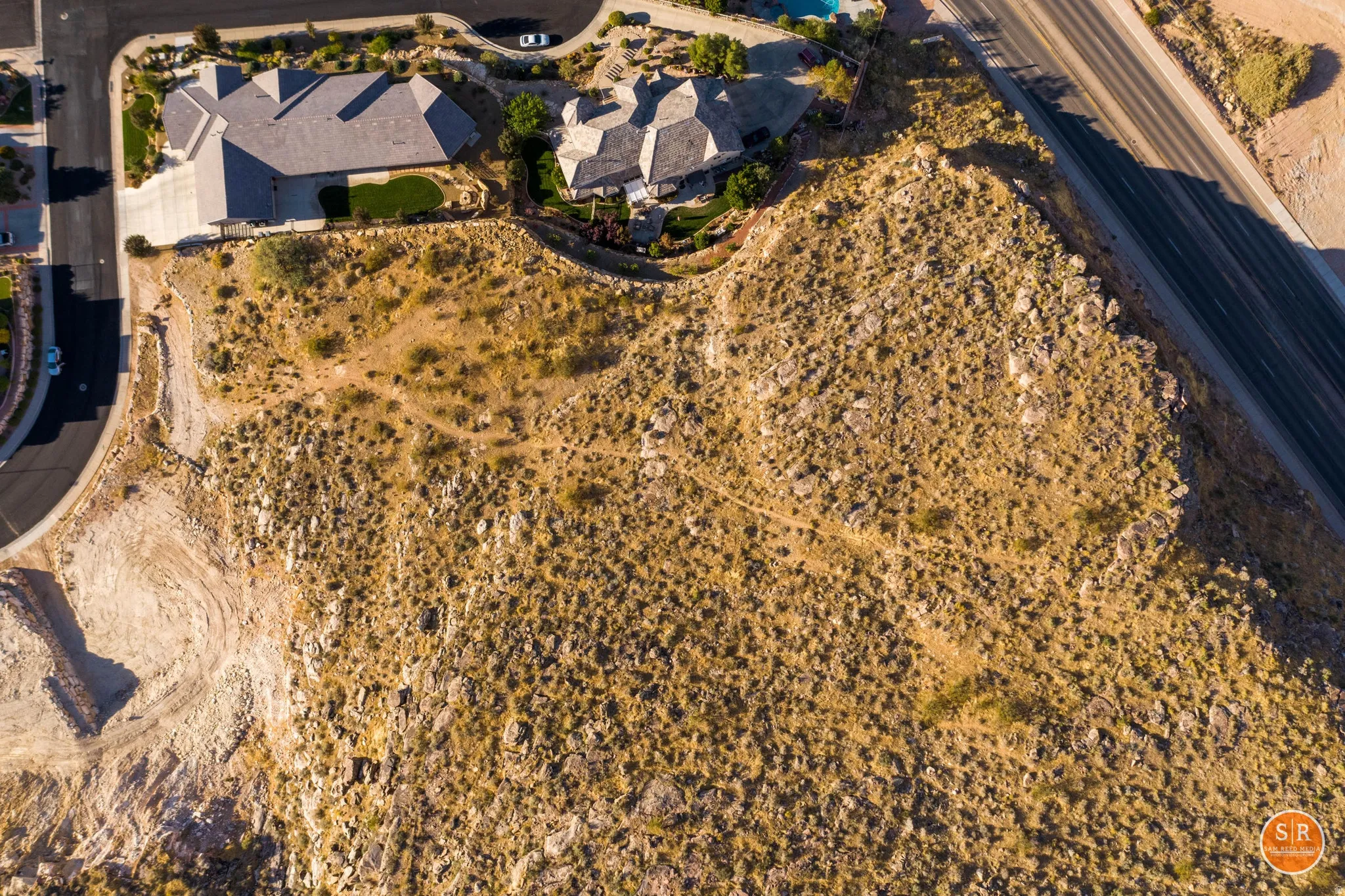 Expansive undeveloped lot featuring natural desert landscaping and scattered rock formations