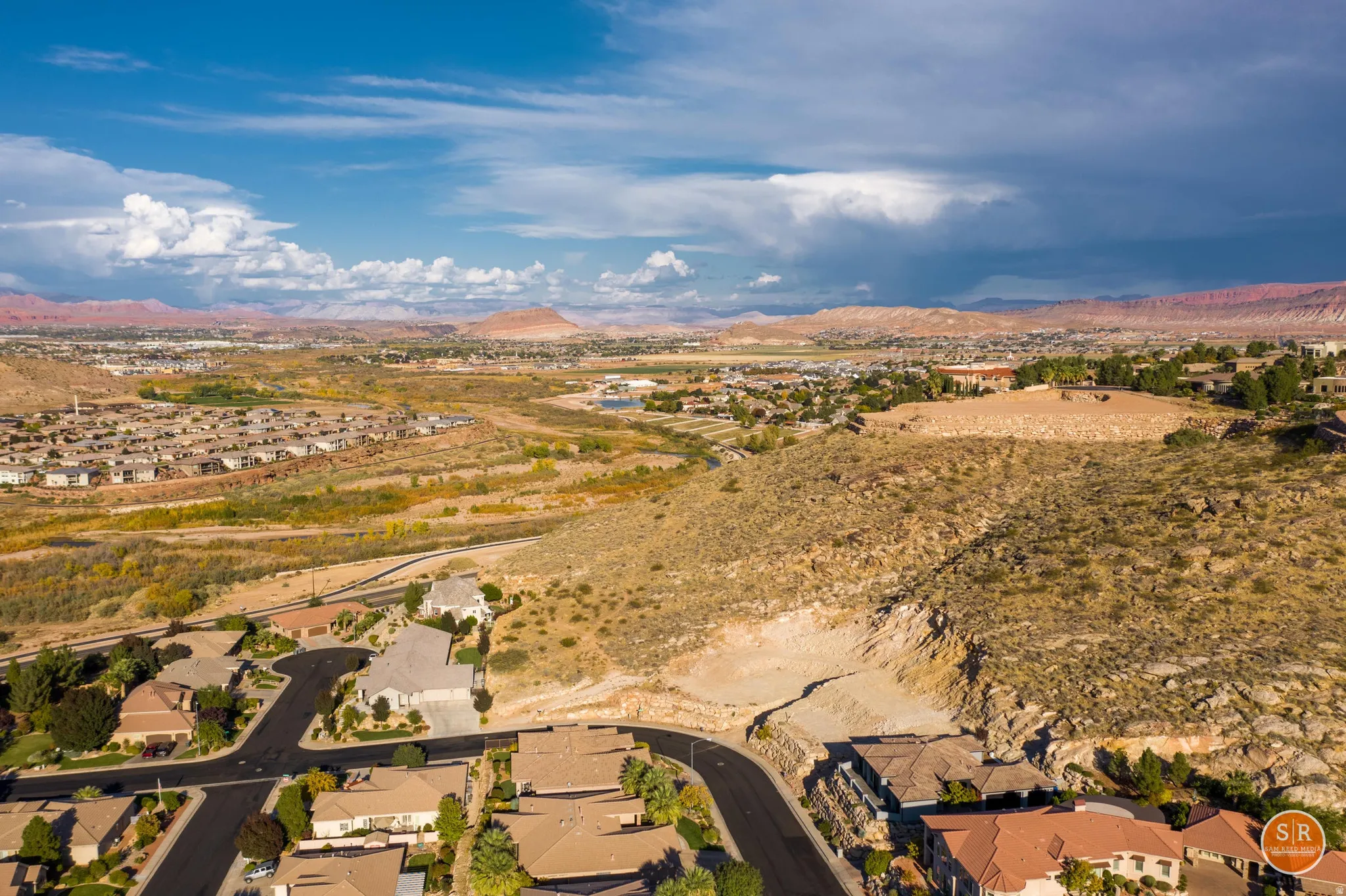 Expansive aerial perspective showcasing a residential neighborhood with varied rooflines and paved streets