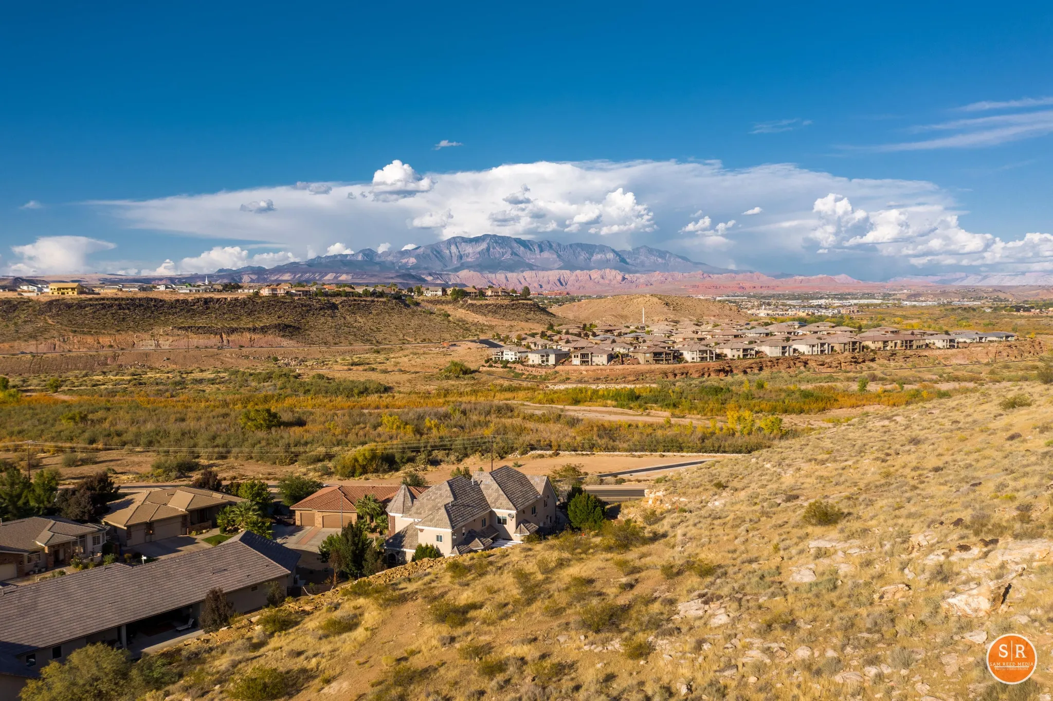 Expansive desert landscape with distant mountains under a blue sky