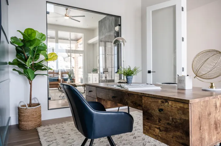 Dedicated workspace featuring wood-finish flooring and a textured area rug