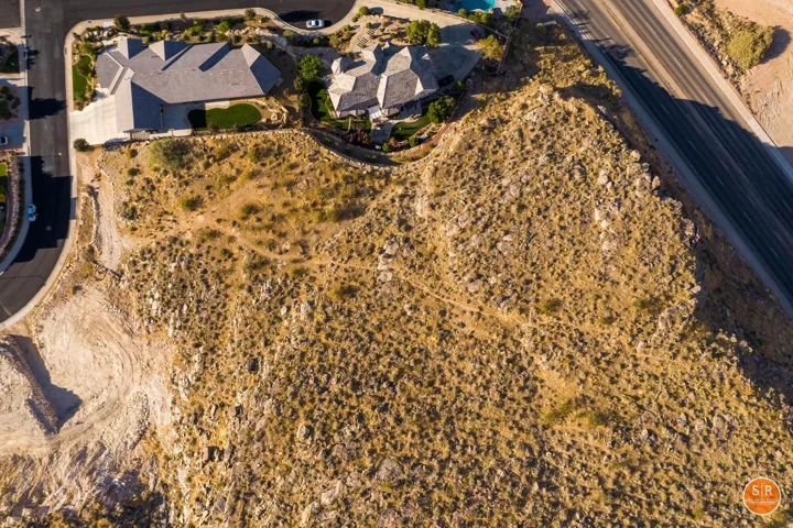 Expansive undeveloped lot featuring natural desert landscaping and scattered rock formations