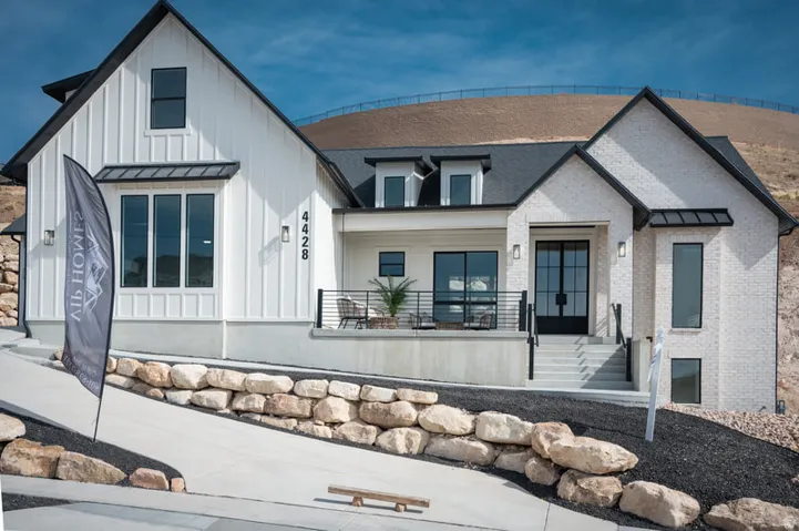 Modern farmhouse exterior featuring board and batten siding and light-colored brick
