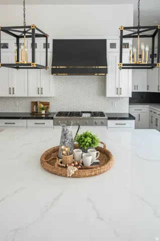 Spacious kitchen island featuring a white countertop with gray veining