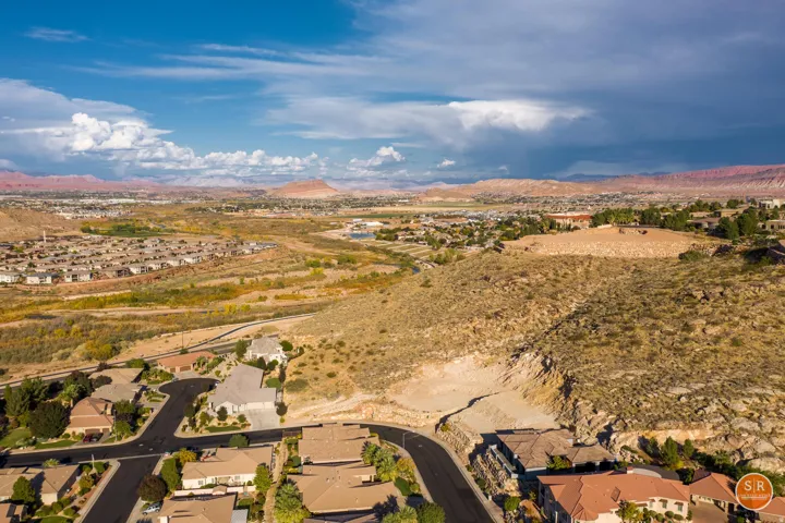 Expansive aerial perspective showcasing a residential neighborhood with varied rooflines and paved streets