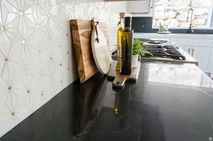 Geometric pattern tile backsplash featuring gold accents