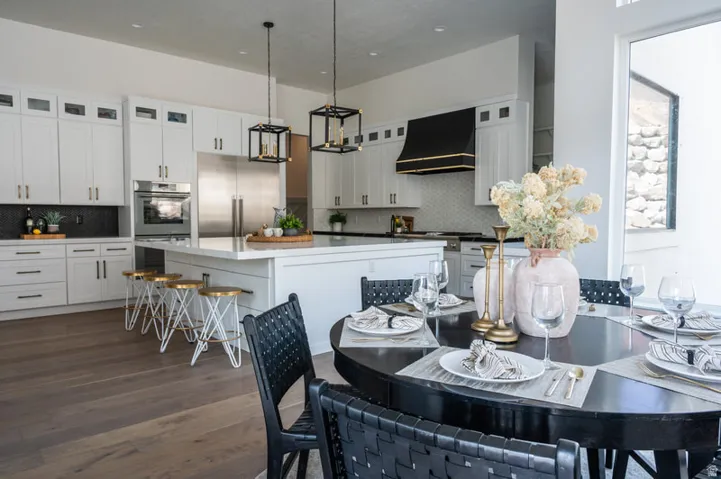 Open-concept kitchen and dining area featuring wide plank wood-finish flooring