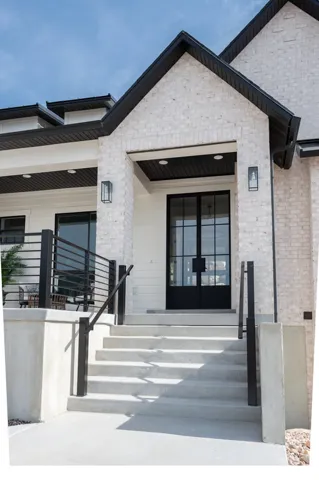Modern brick exterior with black trim accents and a prominent gabled entry