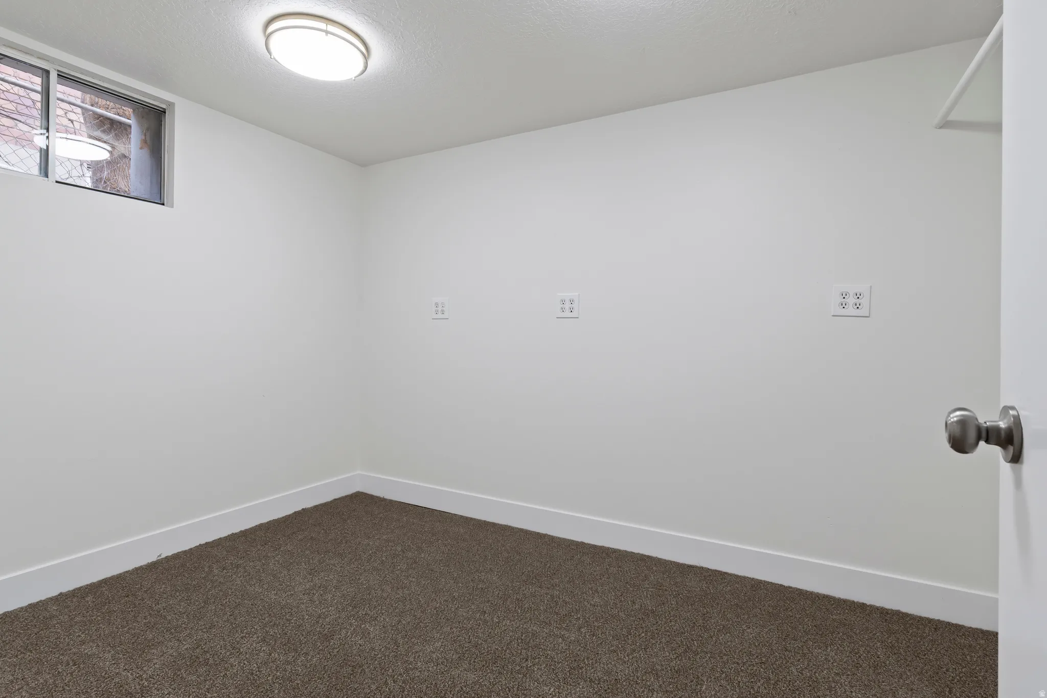 Room with neutral carpet flooring, white painted walls, and a recessed window