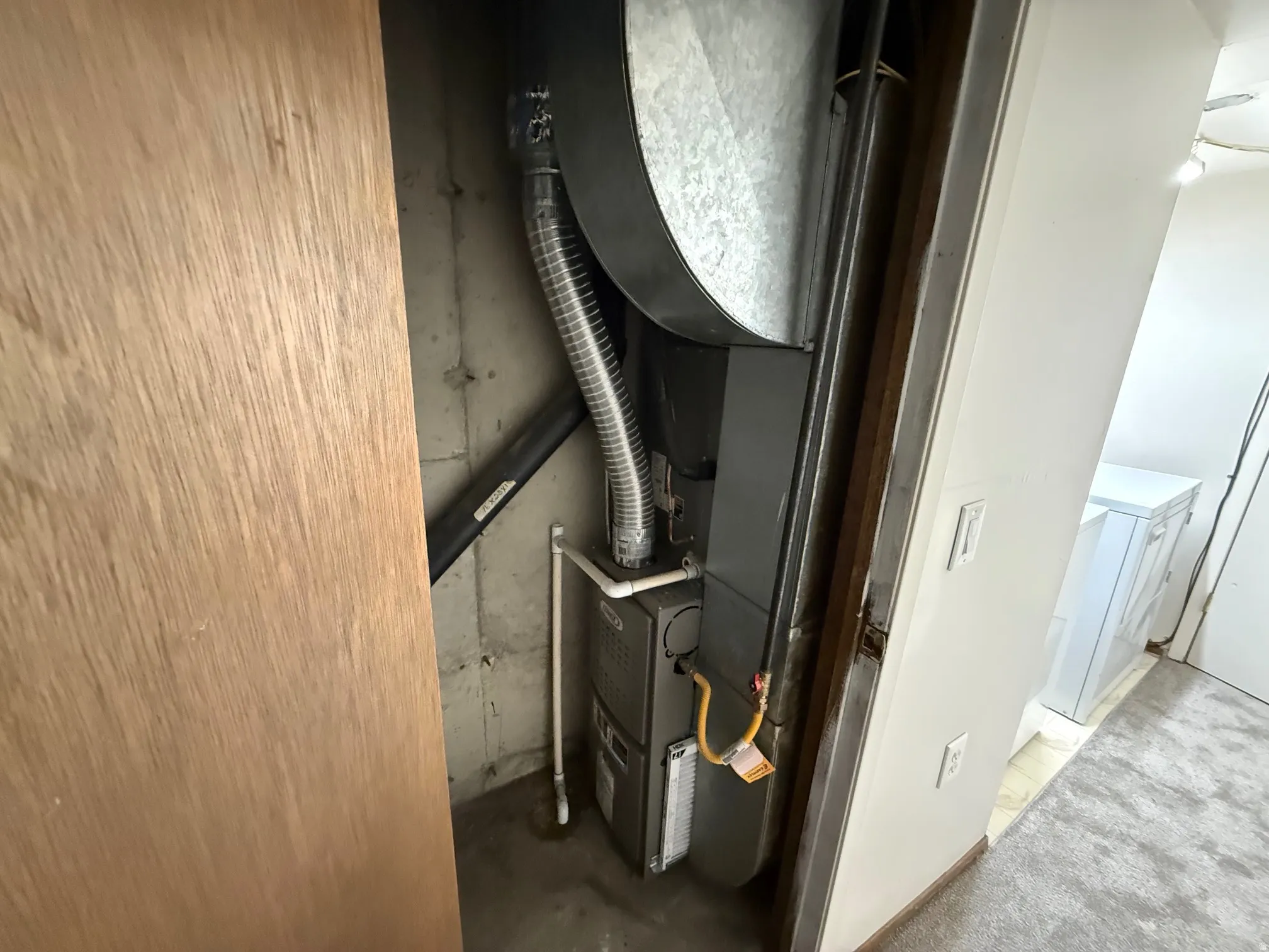 Utility closet featuring a newer HVAC (2023)