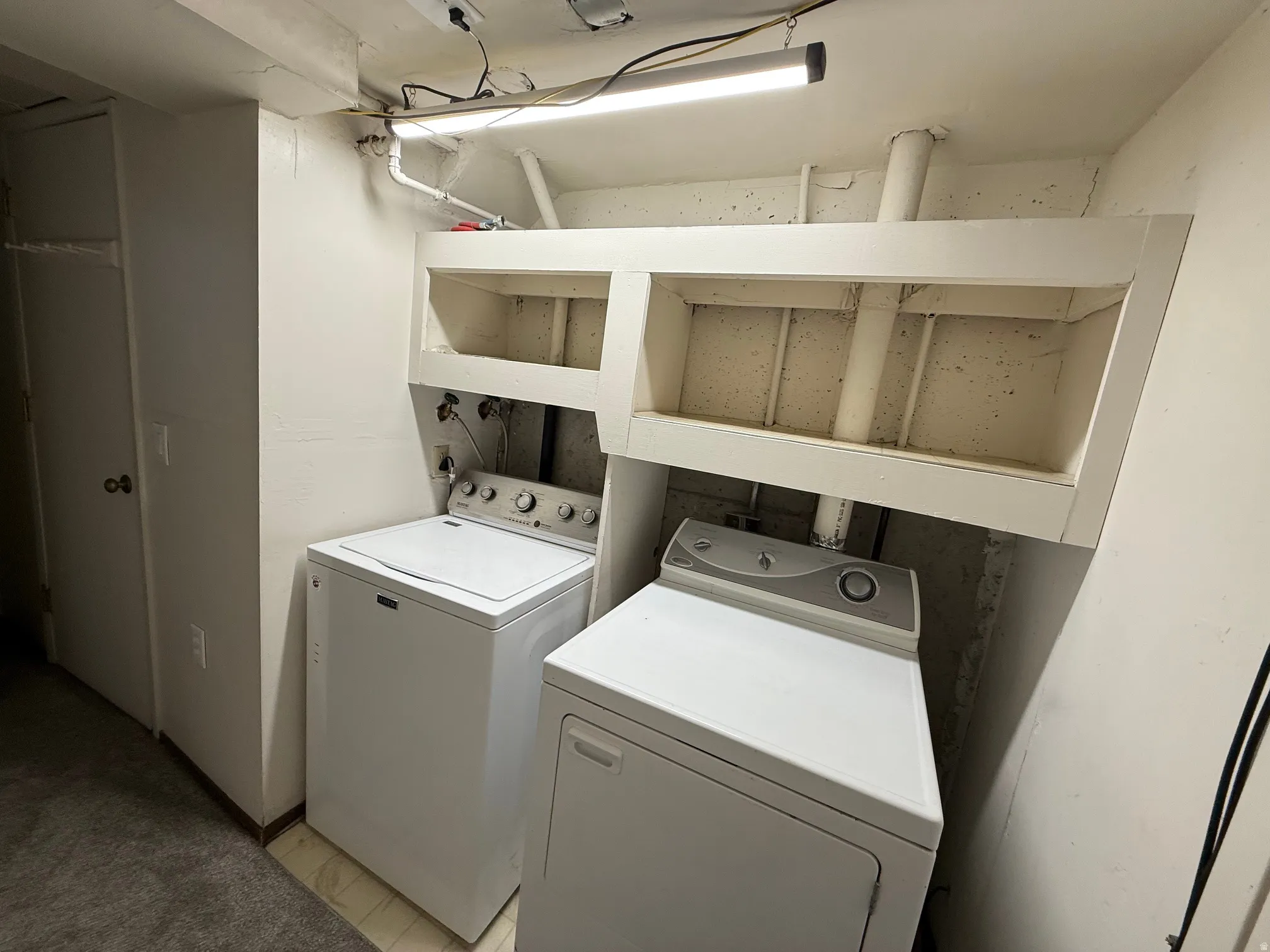 Dedicated laundry area featuring built-in shelving.