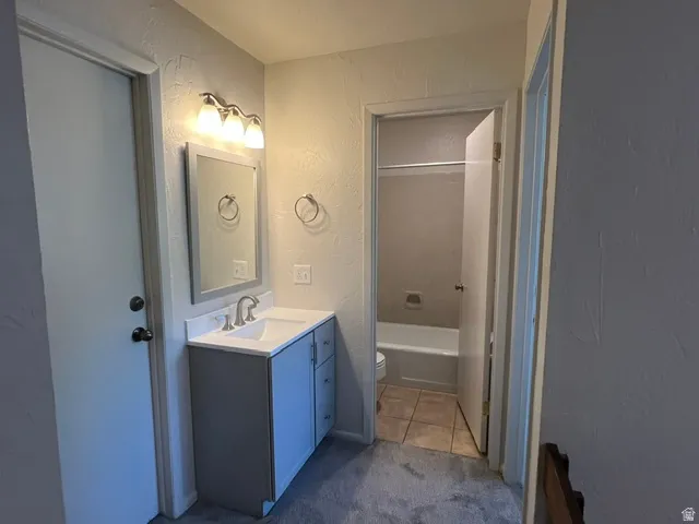 2nd upstairs Bathroom vanity featuring a white countertop, undermount sink, and brushed nickel faucet. Separate tub/shower/toilet room.