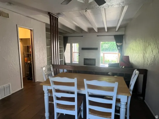Dining area with dark tile wood-finish flooring.