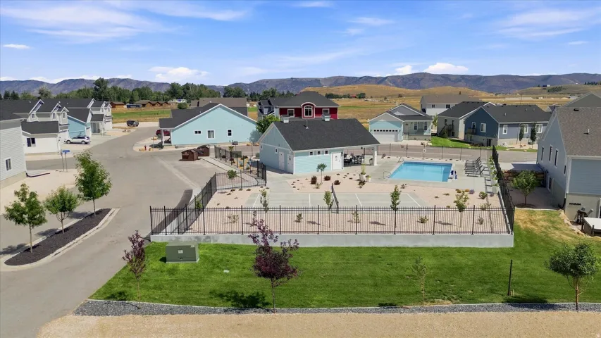 Community with a shared swimming pool, paved roads, and landscaped common areas
