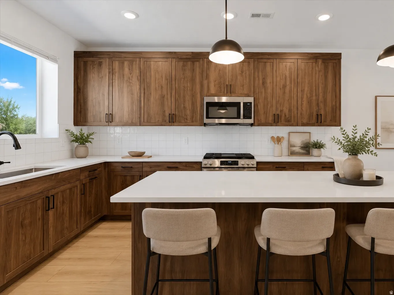 Kitchen featuring wood-finish cabinetry, white countertops, and a subway tile backsplash