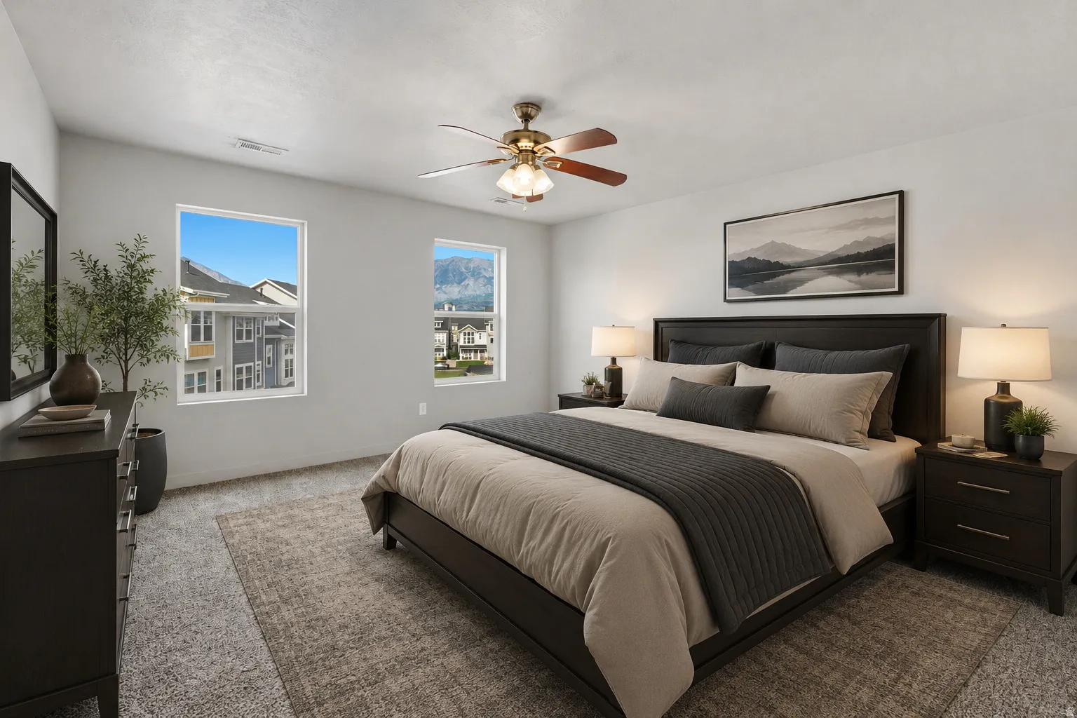 Bedroom featuring light gray walls, plush carpet flooring, a ceiling fan with integrated lighting, and two windows allowing natural light