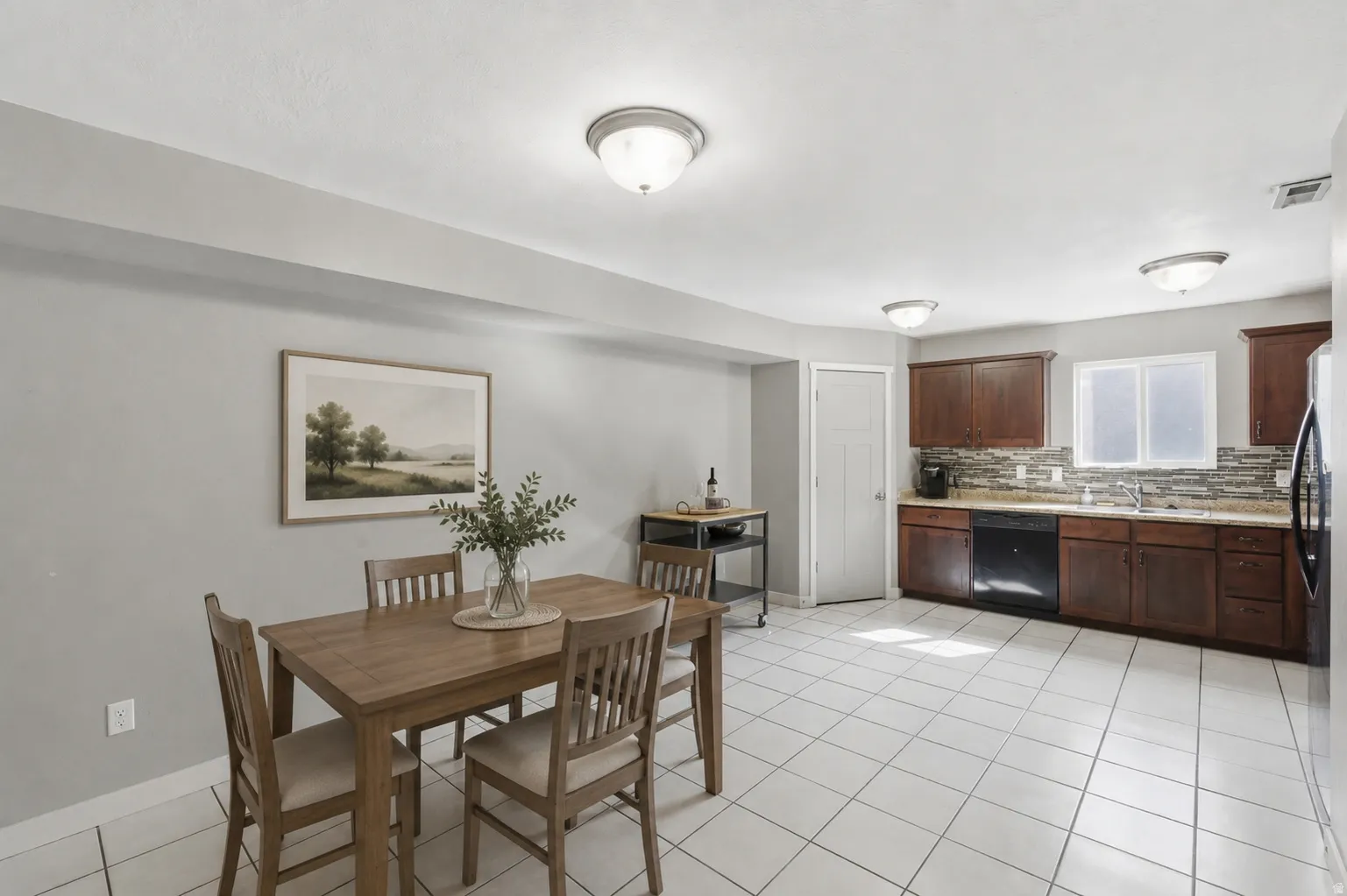 Open-concept kitchen and dining area featuring ceramic tile flooring
