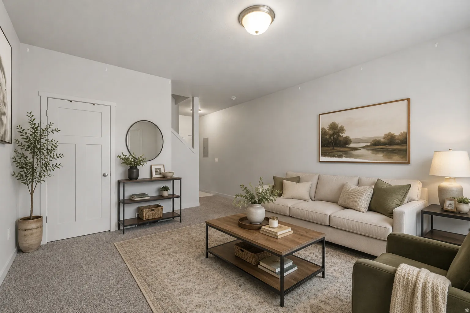 Spacious living area featuring neutral carpeting, a built-in overhead light fixture, and a white paneled door