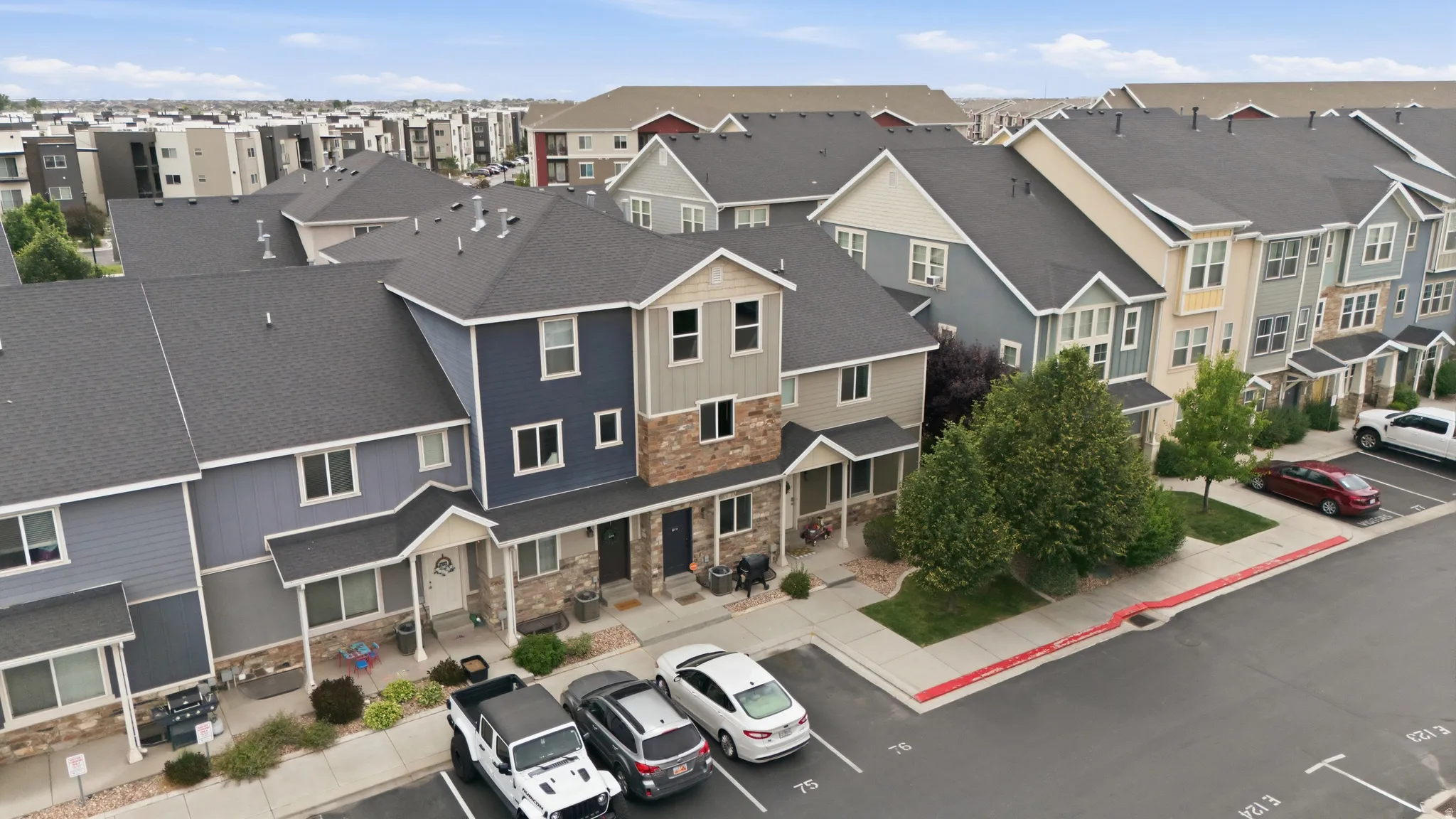Contemporary townhome exteriors featuring varied siding materials and stone accents